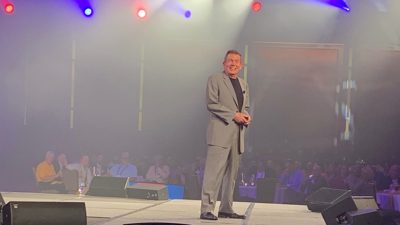 Keynote speaker Terry L. Fossum on stage delivering a keynote to a full ballroom audience.