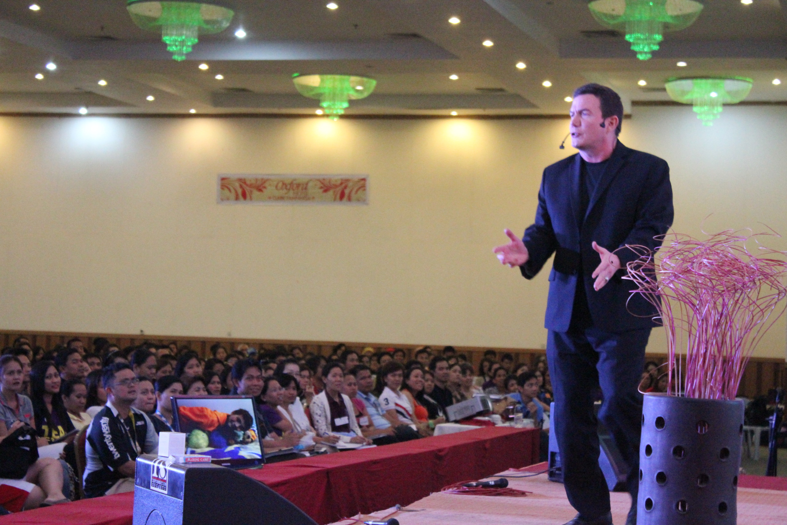 Terry L. Fossum delivering a keynote on a large stage with audience visible