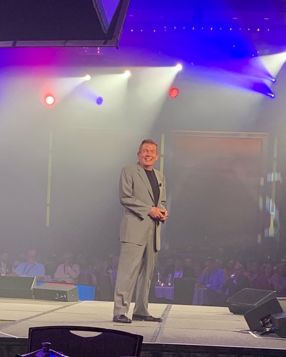 Keynote speaker Terry L. Fossum on a big conference stage under full stage lighting